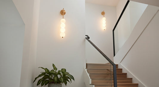 AuraBeam Linear Wall Sconce in Brushed Gold, a modern 'up & down' LED wall lamp with a perforated metal body. VelunaLumin.