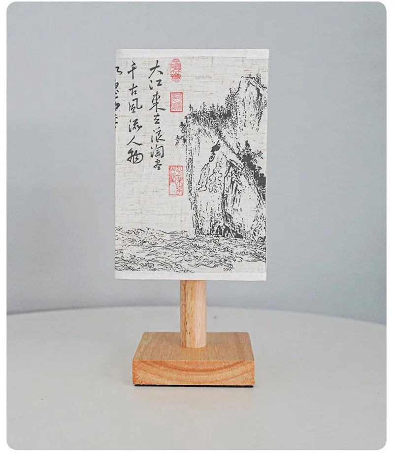 Close-up of the SereneScape Artisan Table Lamp's solid wood base and oriental art linen shade, showcasing its handcrafted quality. VelunaLumin.