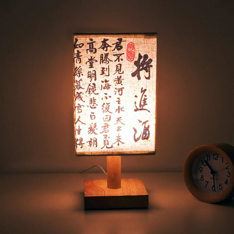 SereneScape Artisan Table Lamp with 'Celestial Cranes' oriental art linen shade, dimmable warm light, and solid wood base. VelunaLumin.