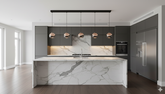 A wide shot of a modern luxury kitchen, where the central marble island is perfectly illuminated by a row of elegant pendant lights from VelunaLumin.