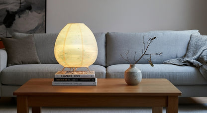 Akari Rice Paper Table Lamp as a decorative centerpiece on a living room side table, adding a touch of minimalist, organic artistry. VelunaLumin.