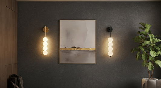 Two AuraBeam Linear Wall Sconces (one Gold, one Black) flanking an abstract artwork in a modern living room, casting architectural 'up & down' light. VelunaLumin.