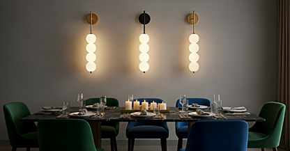 Three AuraBeam Linear Wall Sconces (two Gold, one Black) flanking an abstract artwork in a modern living room, casting architectural 'up & down' light. VelunaLumin.