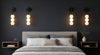 AuraBeam Linear Wall Sconce in Gold mounted beside a bed, providing a sophisticated and warm ambient glow in a contemporary bedroom. VelunaLumin.