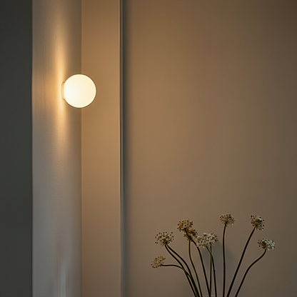 Close-up of the AuraOrb Ceiling Light showing the detail of the frosted glass globe and the premium metal base in a brushed gold finish. VelunaLumin.