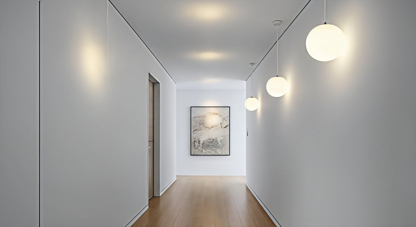 A series of AuraOrb Minimalist Ceiling Lights in Gold and Black illuminating a modern hallway, creating a rhythmic and serene path of light. VelunaLumin.