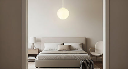 A single gold-finish AuraOrb ceiling light in the center of a guest bedroom, demonstrating a minimalist, functional, and welcoming lighting solution. VelunaLumin