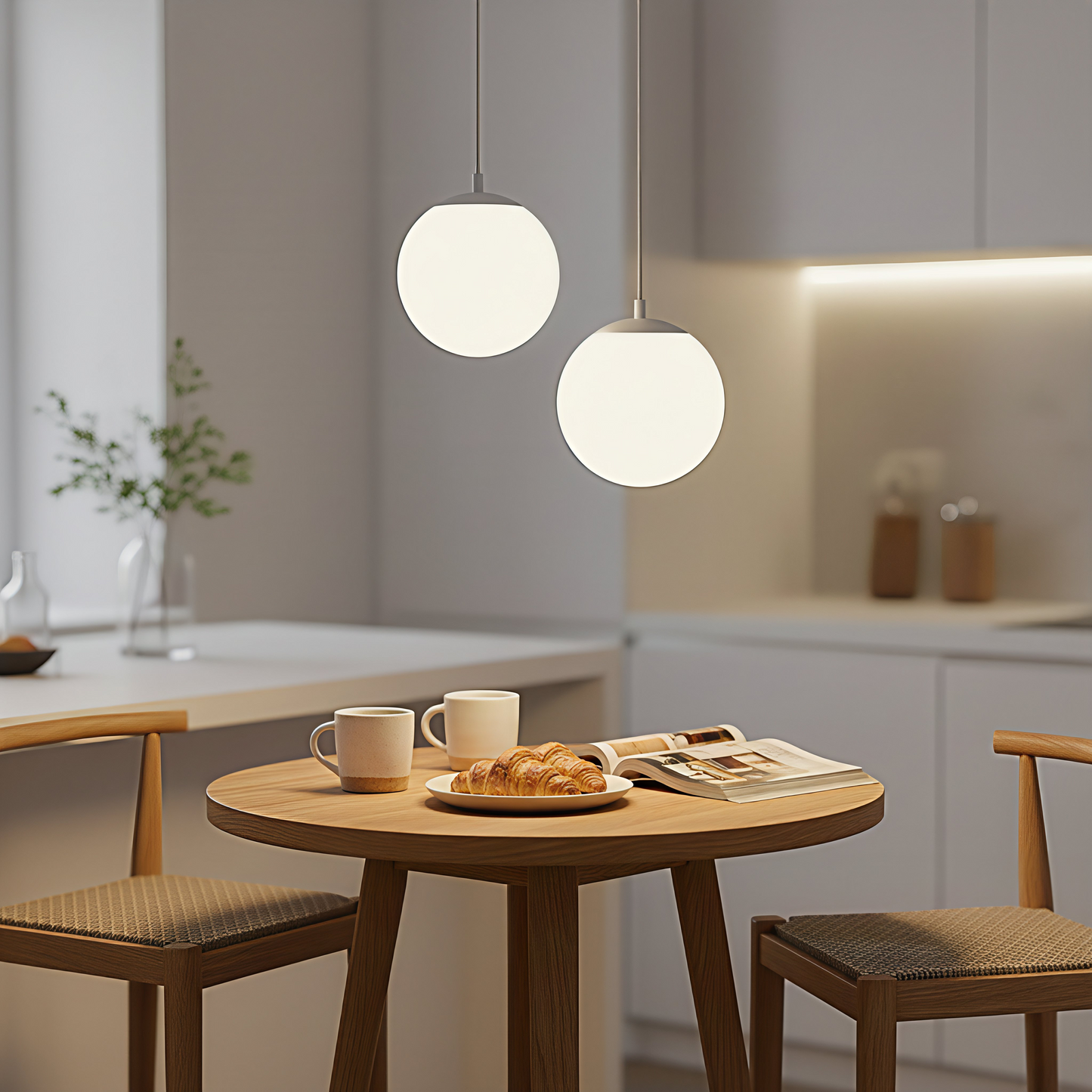 A pair of gold-finish AuraOrb ceiling lights hanging over a cozy coffee nook, creating a warm and chic ambiance. VelunaLumin.