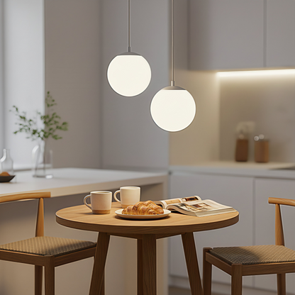 A pair of gold-finish AuraOrb ceiling lights hanging over a cozy coffee nook, creating a warm and chic ambiance. VelunaLumin.