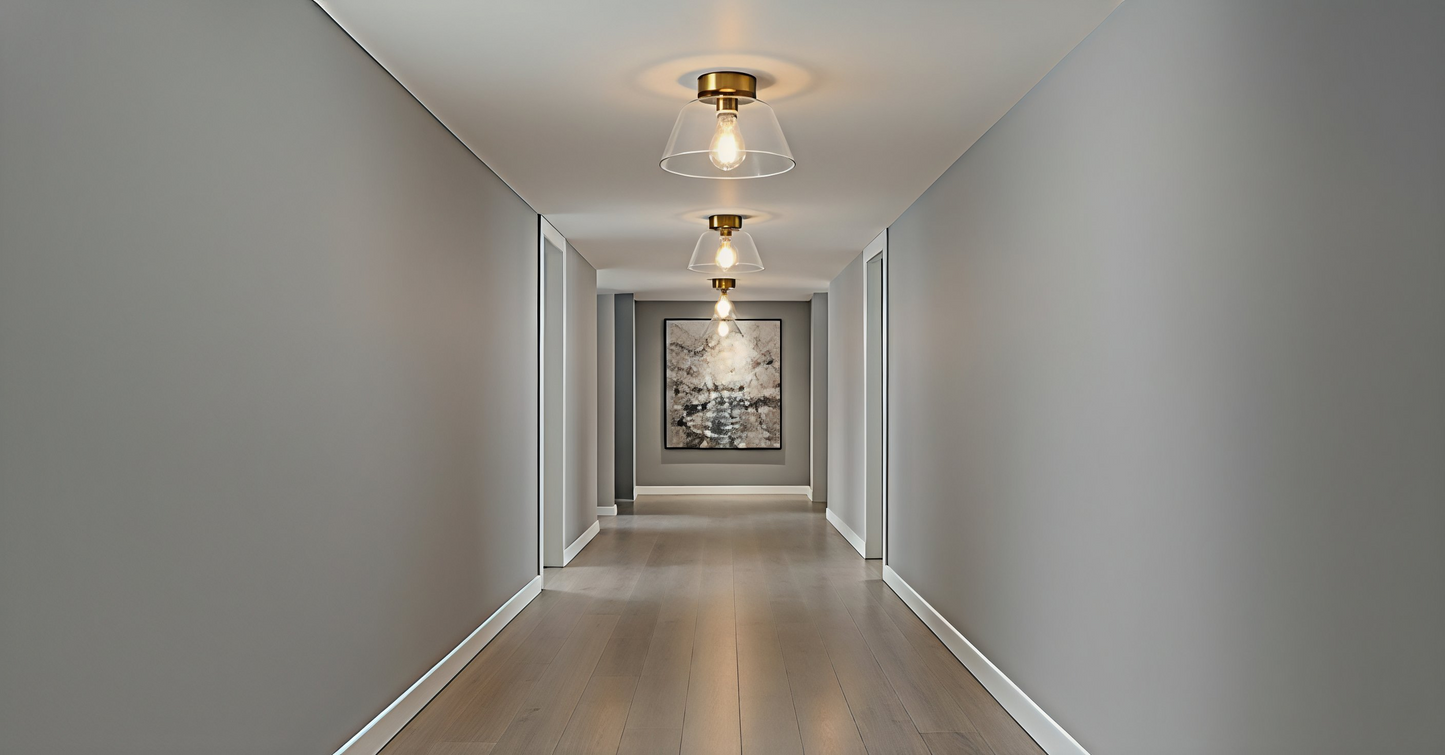 A series of AuraSphere Ceiling Lights in mixed Amber, Green, and Transparent glass illuminating a minimalist hallway, creating a rhythmic and sophisticated path of light. VelunaLumin