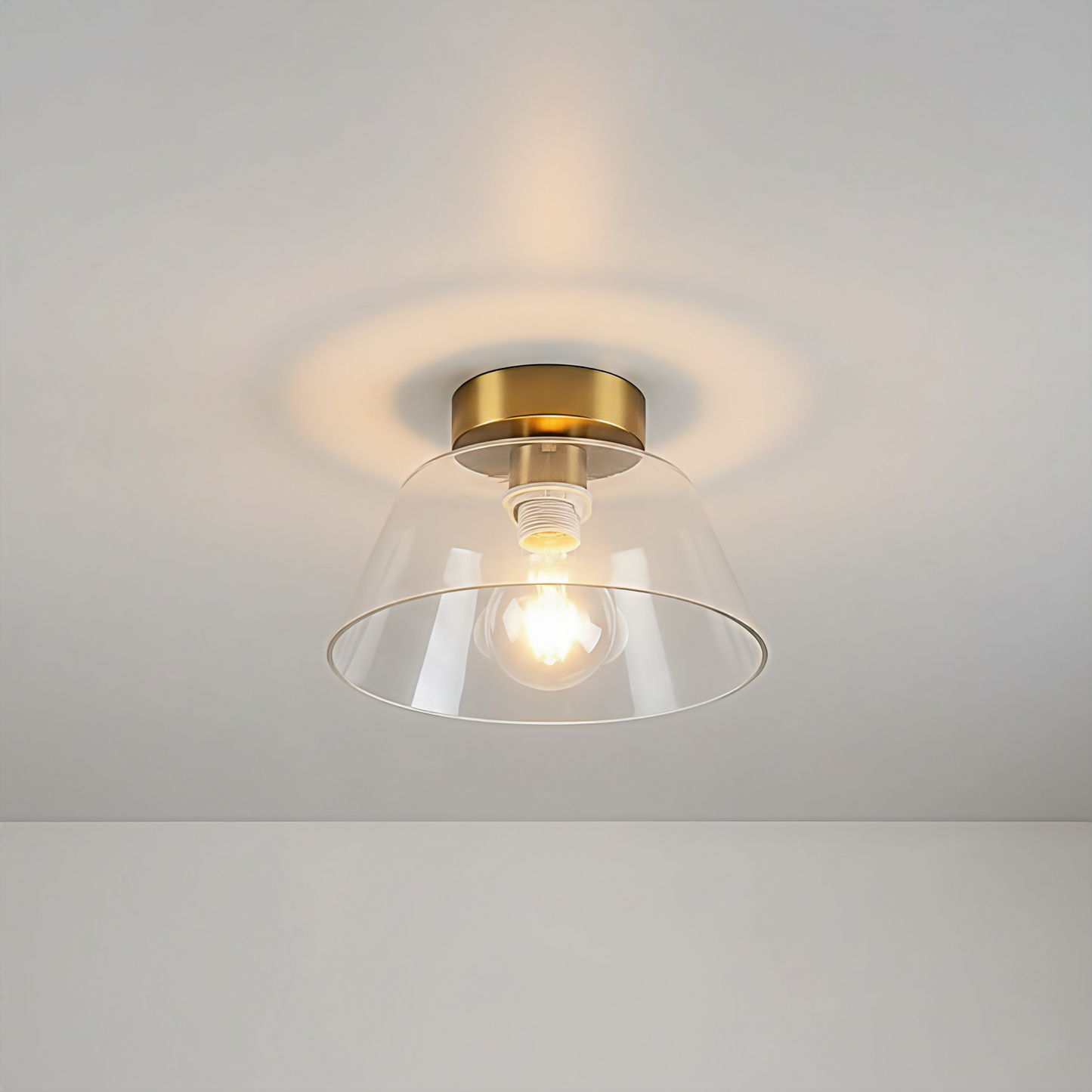 AuraSphere Glass Ceiling Light in a crystal-clear Transparent glass finish, featuring a modern gold base, surface mounted. VelunaLumin.