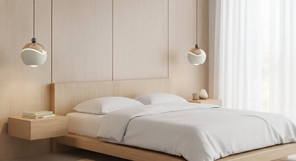 Two AuraSpire pendants in Off-White used as minimalist bedside lighting in a serene, modern bedroom. VelunaLumin.