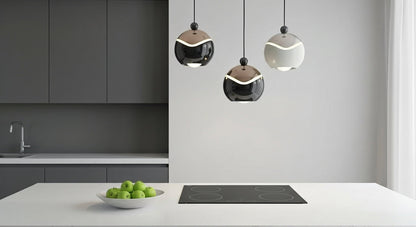 A cluster of AuraSpire pendants in Black and Off-White hanging over a modern white marble kitchen island, providing focused LED light. VelunaLumin.