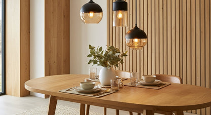 LuminaGrace Rich Amber & Clear Glass Slim Cylinder Pendant Light hanging above a velvet bedside table, casting a warm, intimate glow in a luxurious bedroom setting, VelunaLumin.