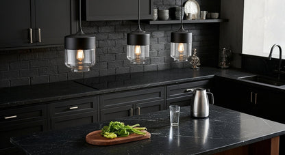 Three LuminaGrace Sleek Black & Smoke Glass Sphere Pendant Lights illuminating a minimalist kitchen island with dark marble, providing modern and functional lighting, VelunaLumin.