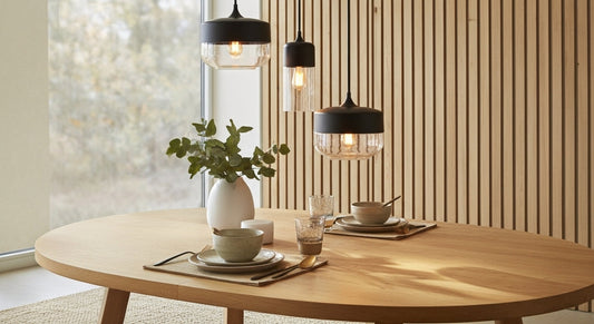 Three LuminaGrace Sleek Black & Smoke Glass Sphere Pendant Lights illuminating a minimalist kitchen island with dark marble, providing modern and functional lighting, VelunaLumin.