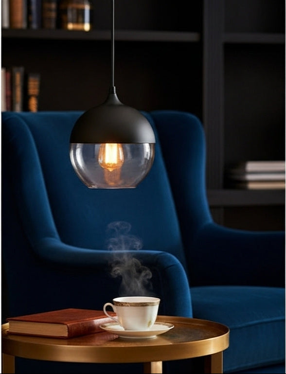 Three LuminaGrace Sleek Black & Smoke Glass Sphere Pendant Lights illuminating a minimalist kitchen island with dark marble, providing modern and functional lighting, VelunaLumin.
