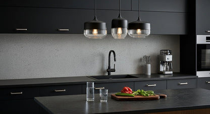 Three LuminaGrace Sleek Black & Smoke Glass Sphere Pendant Lights illuminating a minimalist kitchen island with dark marble, providing modern and functional lighting, VelunaLumin.