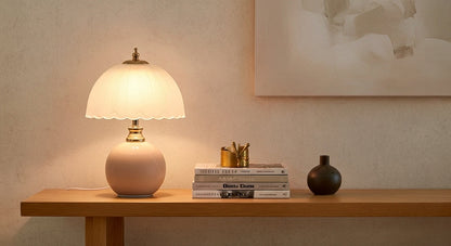 NouveauGlow Murano-Style Mushroom Lamp in Pastel Pink on a bedside table, casting a soft, dimmable warm light in a modern bedroom. VelunaLumin.