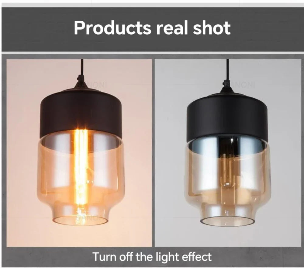 Close-up of LuminaGrace Rich Amber & Clear Glass Slim Cylinder Pendant Light, highlighting the rich amber metal base and pristine clear glass shade, showcasing the bulb within, VelunaLumin exclusive design.