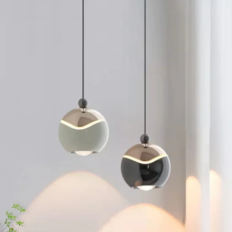 Two AuraSpire pendants in Off-White and Black used as minimalist bedside lighting in a serene, modern bedroom. VelunaLumin