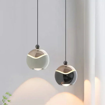 Two AuraSpire pendants in Off-White and Black used as minimalist bedside lighting in a serene, modern bedroom. VelunaLumin