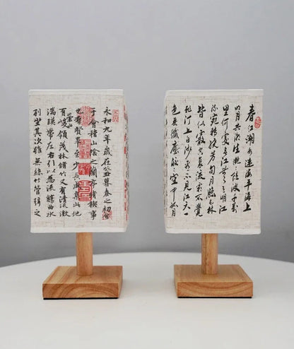 Close-up of the SereneScape Artisan Table Lamp's solid wood base and oriental art linen shade, showcasing its handcrafted quality. VelunaLumin.
