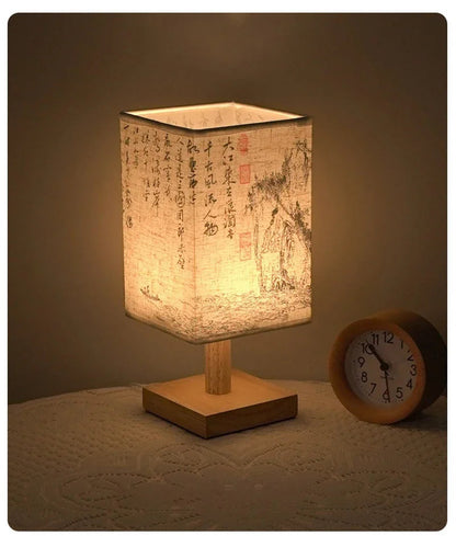 Close-up of the SereneScape Artisan Table Lamp's solid wood base and oriental art linen shade, showcasing its handcrafted quality. VelunaLumin.