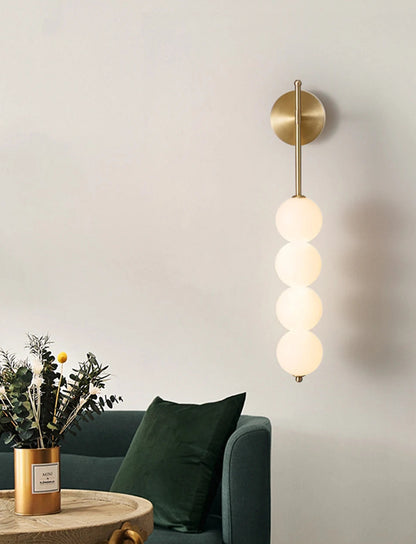 AuraBeam Linear Wall Sconce in Brushed Gold, a modern 'up & down' LED wall lamp with a perforated metal body. VelunaLumin.