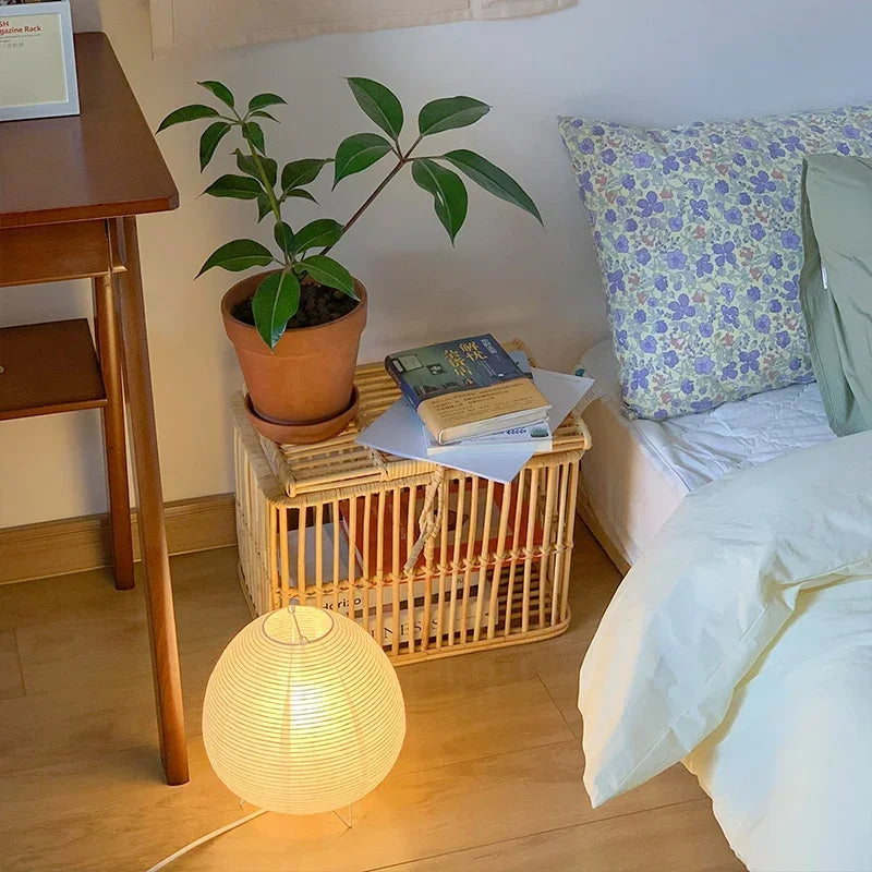 Akari Rice Paper Table Lamp on a minimalist bedside table, providing a serene and cozy ambient light in a modern Japandi-style bedroom. VelunaLumin.
