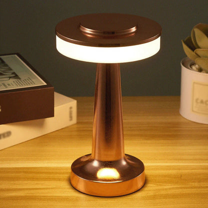 Close-up of a hand touching the top of the AuraGlow Cordless Touch Lamp to adjust brightness and light color. VelunaLumin.
