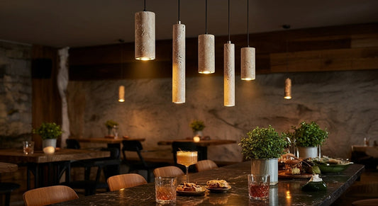 TerraGlow Natural Stone Pendant Lights in a line above a stylish cafe bar, offering sophisticated 3000K warm ambient lighting for an exclusive commercial setting. VelunaLumin.
