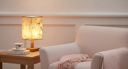 SereneScape 'Sakura Bloom' table lamp on a minimalist bedside table, casting a cozy, dimmable warm light in a modern bedroom. VelunaLumin.