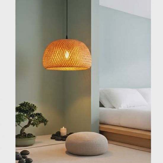 A ZenWeave 'Harmony Dome' bamboo pendant light suspended over a low coffee table in a minimalist, Japanese-style living room, providing a soft, natural ambient glow. VelunaLumin.