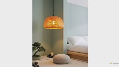 A ZenWeave 'Harmony Dome' bamboo pendant light suspended over a low coffee table in a minimalist, Japanese-style living room, providing a soft, natural ambient glow. VelunaLumin.