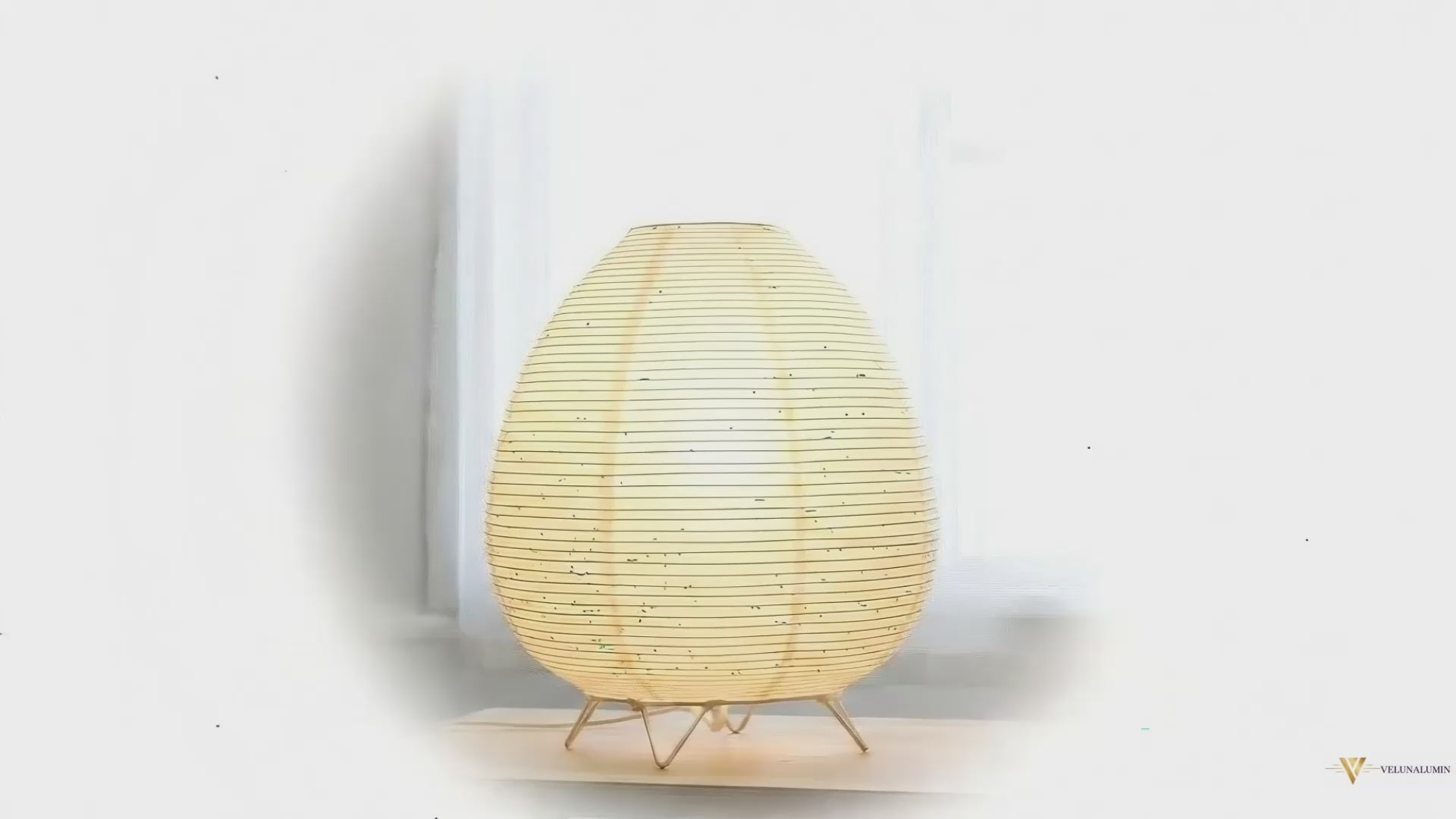 Akari Rice Paper Table Lamp with a sculptural, organic design inspired by Japanese Wabi-Sabi aesthetics, casting a warm, diffused light. VelunaLumin.